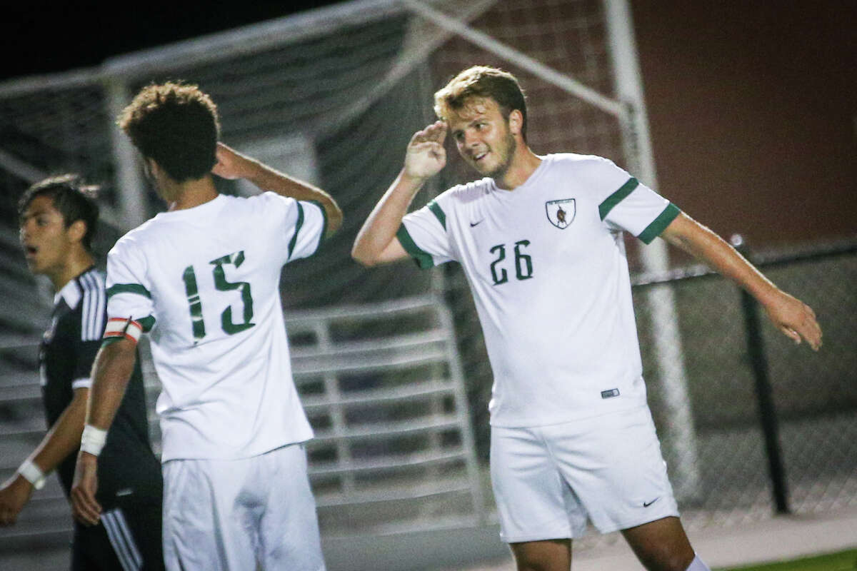 The WoodlandsÂ?’ Nicholas Pekel (26) throws a salute after scoring a goal to Wesley Mitchell (15) during the varsity boys soccer game against Conroe on Tuesday, March 7, 2017, at Woodforest Bank Stadium. (Michael Minasi / Chronicle)