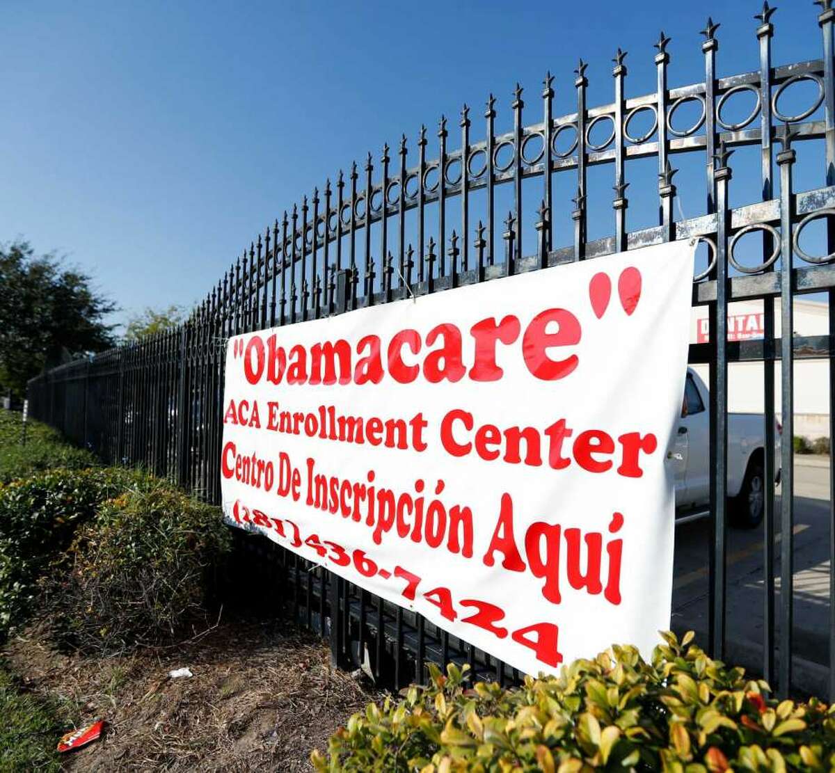 A sign outside a Houston community center advertises for enrollment in Affordable Care Act individual health care plans. 