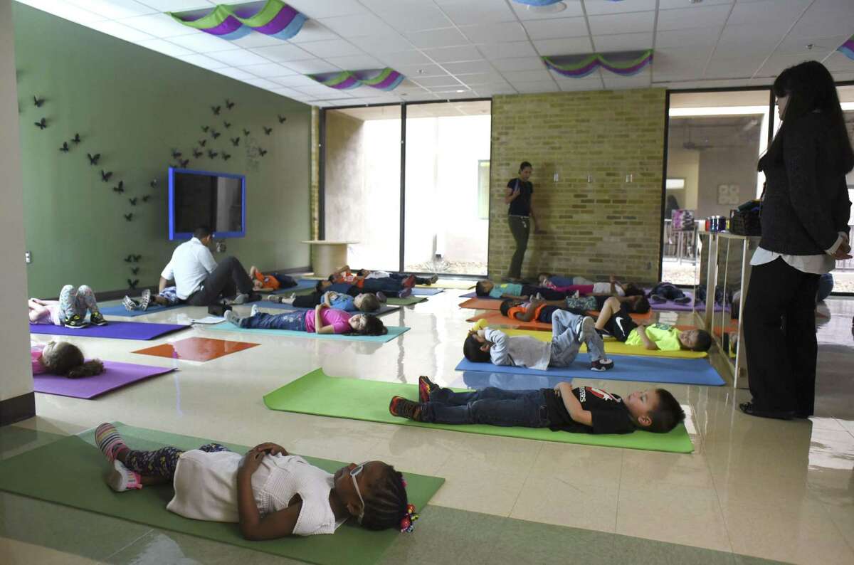 Children at the Pre-K 4 SA North Education Center relax with yoga on Tuesday, Feb. 28, 2017. The program was selected as a finalist for the HEB Excellence in Education Awards.