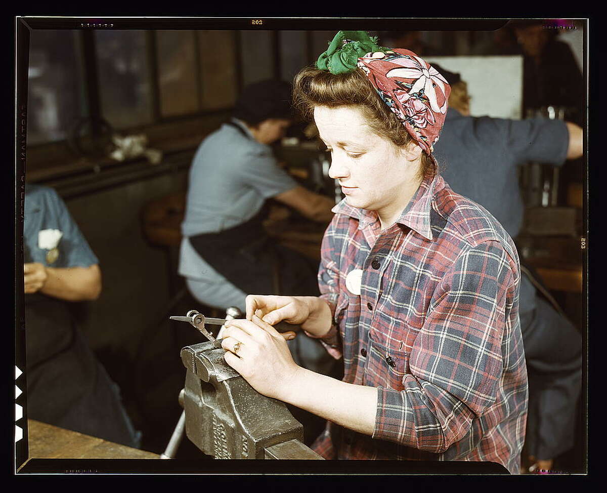 One of the girls of Vilter [Manufacturing] Co. filing small gun parts, Milwaukee, Wisc. One brother in Coast Guard, one going to Army. 1943 Feb. Hollem, Howard R., photographer.