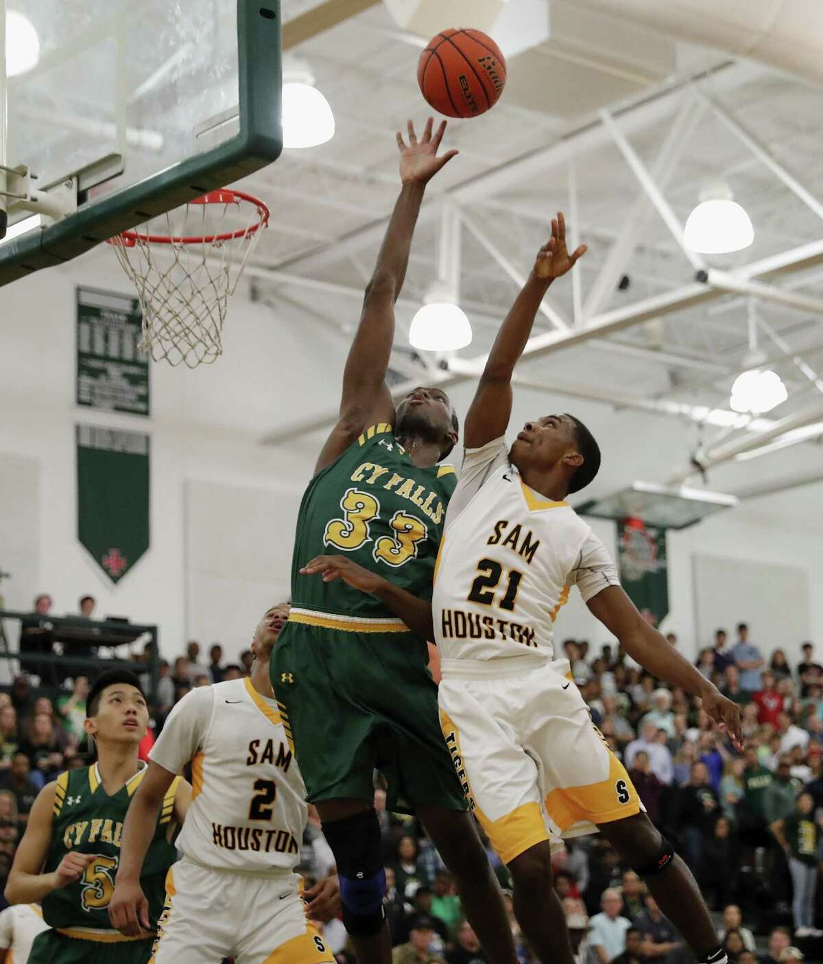 Houston Cy Falls’ Deshang Weaver (33) blocks a shot by Sam Houston’s Anthony Fletcher (21) during the first half of the 6A Region III playoff game at Strake Jesuit High School in Houston on Feb. 28, 2017.