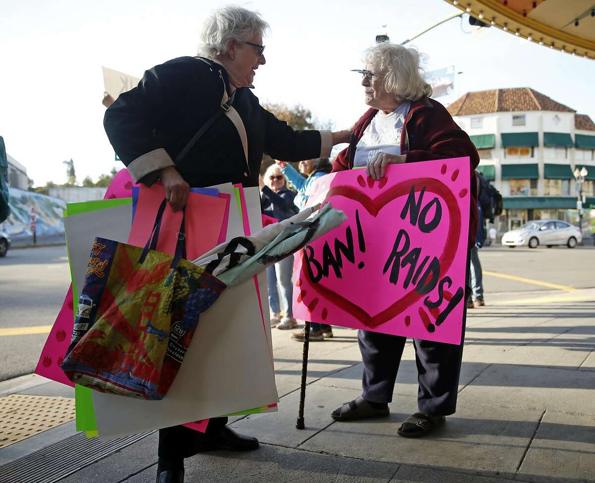 Indivisible founder Alice Phillips (left) greets Margaret Hasselman during weekly protest by the grassroots organization on Grand Avenue in Oakland, Calif., on Tuesday, March 7, 2017.