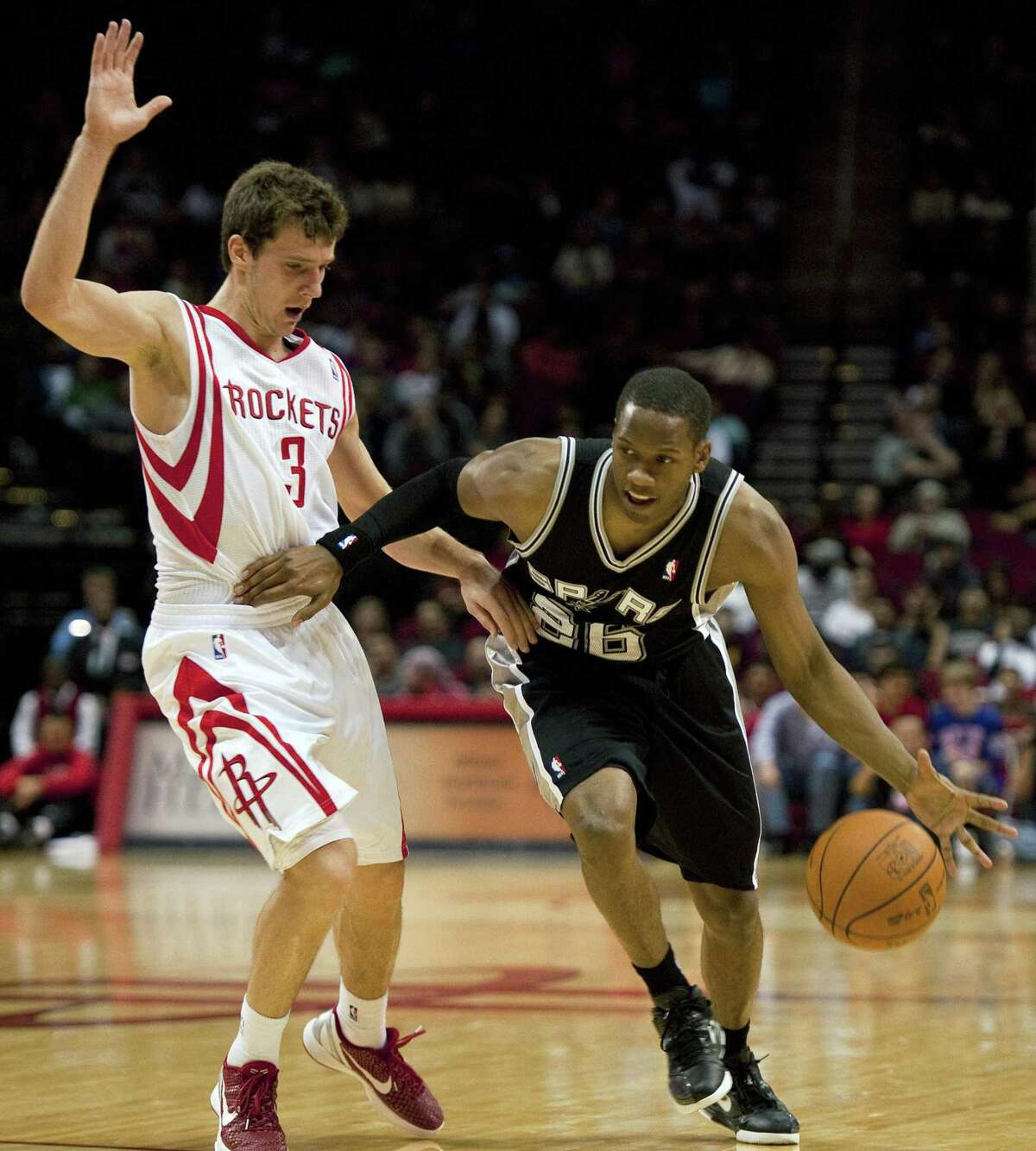 Spurs’ Antoine Hood drives around the Rockets’ Goran Dragic during the fourth quarter of a preseason game on Dec. 17, 2011, in Houston.