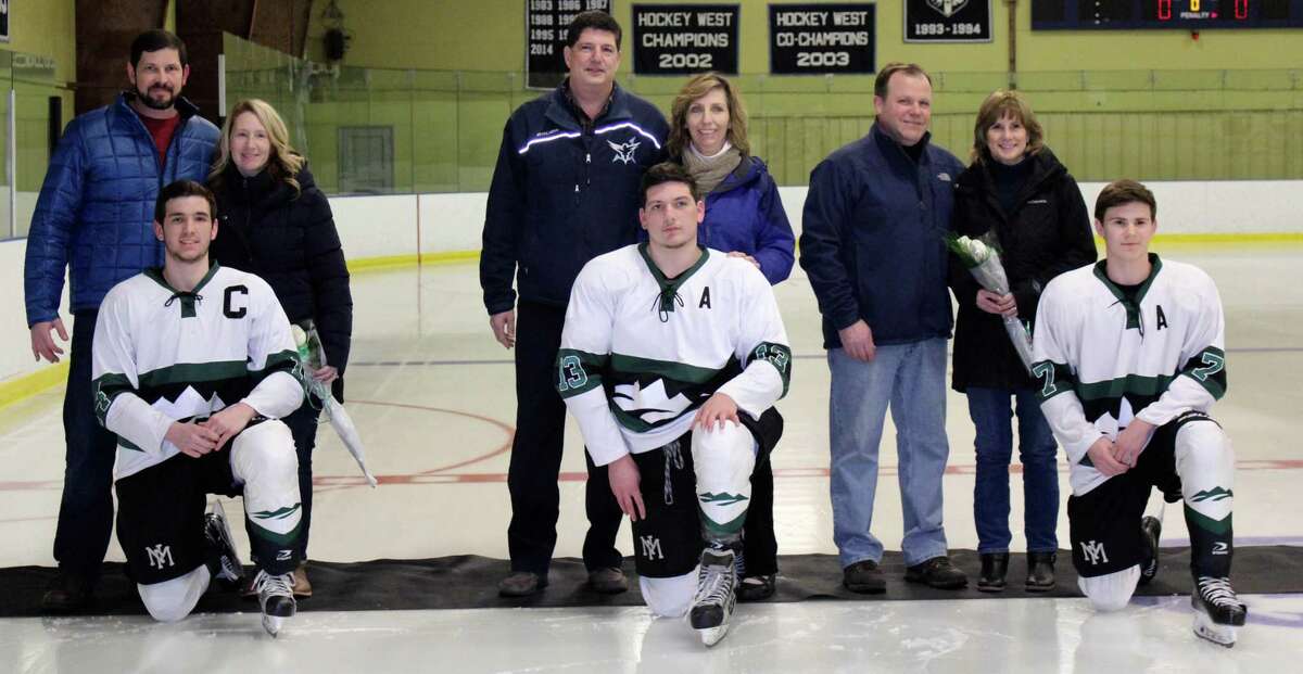 The New Milford High School boys’ ice hockey team recently wrapped up its final regular game of the season, winning the game against East Catholic in over time. The score of the Feb. 22 game was 3-2. The game was also senior night. Above, players are shown with their parents from left to right: Payton Meyer with his parents, Heather and John; Christian Schopfer with his parents, Larry and Bernadette; and Thomas Schneider with his parents, Mike and Cindy.
