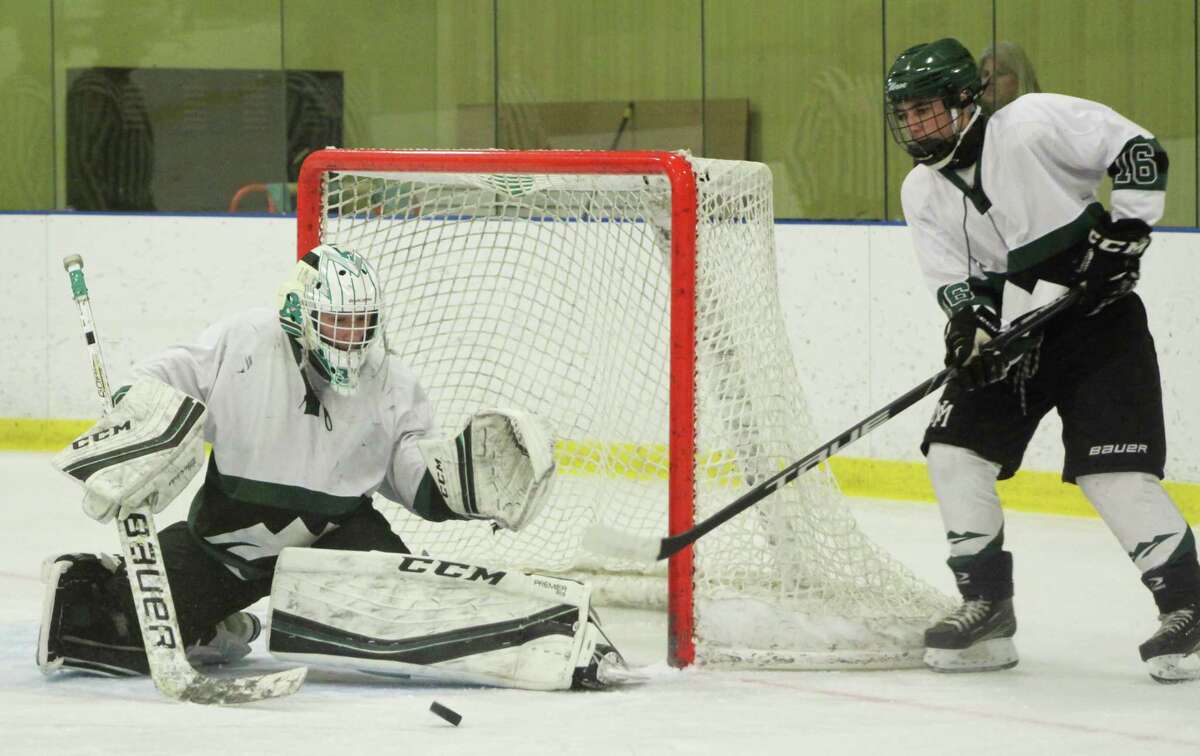 New Milford High School sophomore Ben Marano makes a save during the game.
