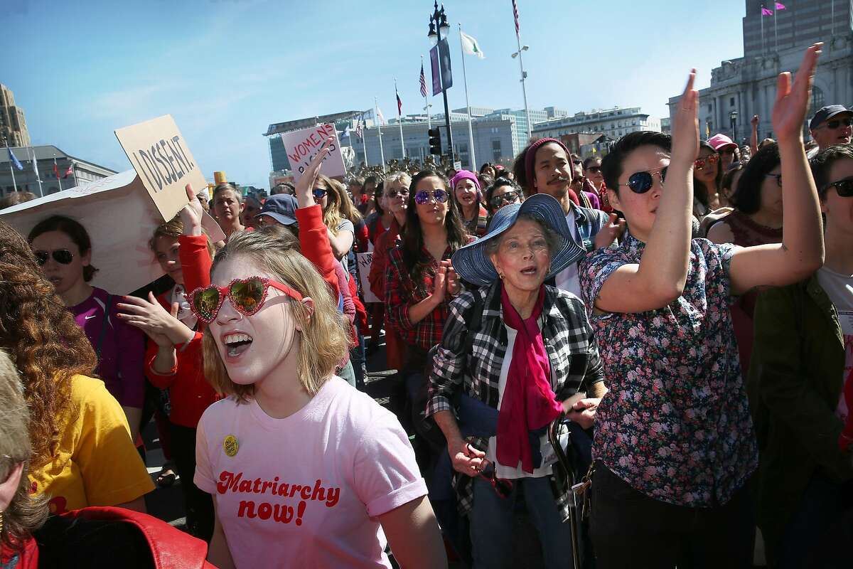 Emma Eisler (left), 18 years old, from Menlo Park in front of city hall during International Women's Day on Wednesday, March 8, 2017, in San Francisco, Calif.