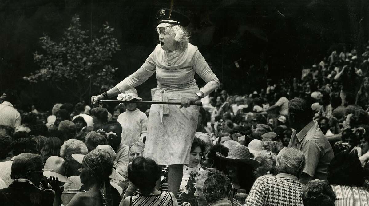 Gladys Sargent dances on a picnic table during the Preservation Hill Jazz band concert in Stern Grove in San Francisco on July 11, 1980.
