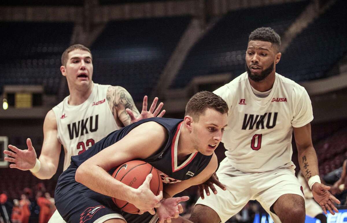 UTSA center Lucas O’Brien (15) calls a timeout as he is trapped by Western Kentucky forwards Justin Johnson (23) and Jabari McGhee (0) during the Conference USA tournament, Wednesday, March 8, 2017, at Legacy Arena in Birmingham, Ala.