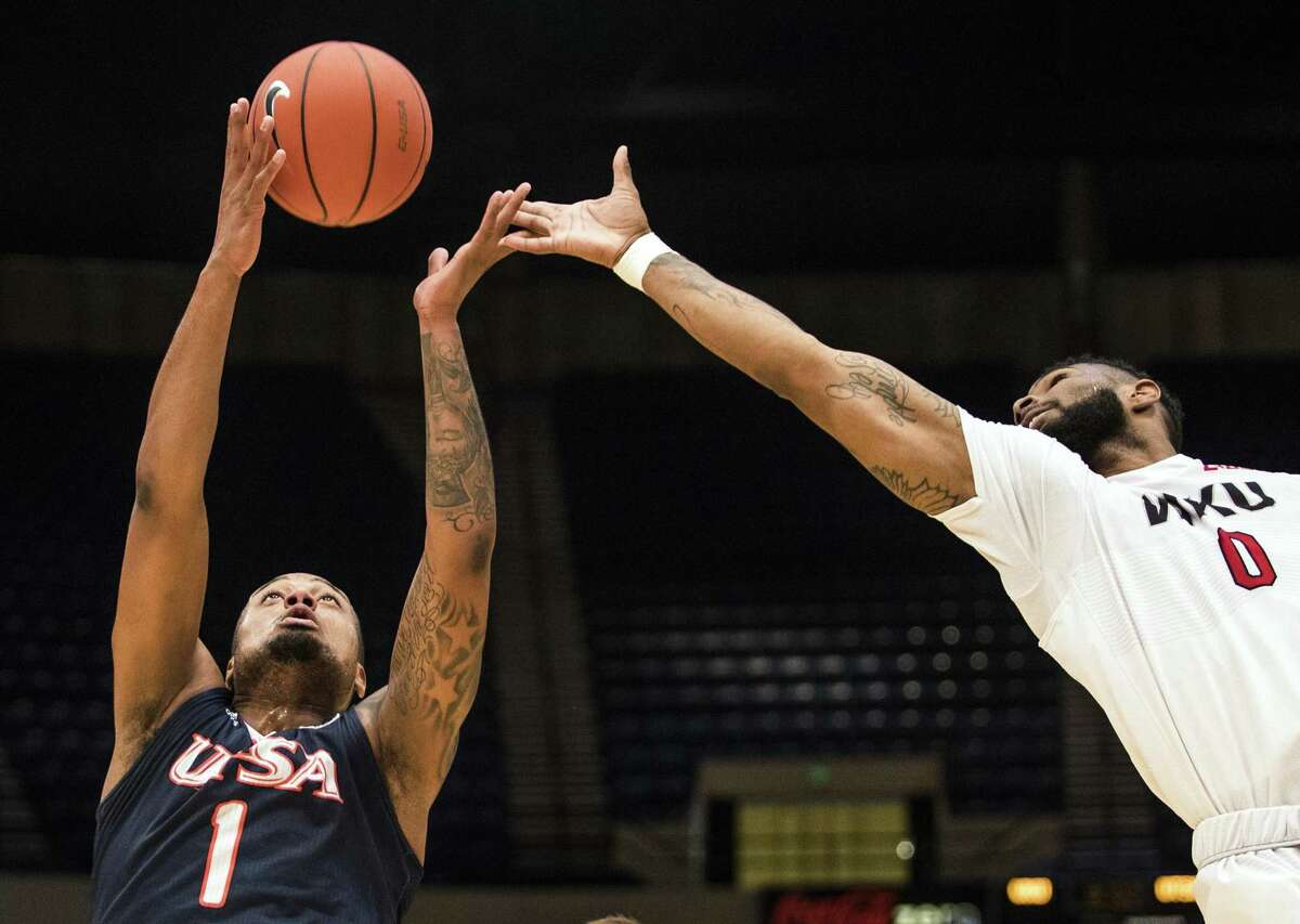 UTSA forward Jeff Beverly (1) grabs a rebound ahead of Western Kentucky forward Jabari McGhee (0) in the Conference USA tournament, Wednesday, March 8, 2017, at Legacy Arena in Birmingham, Ala.
