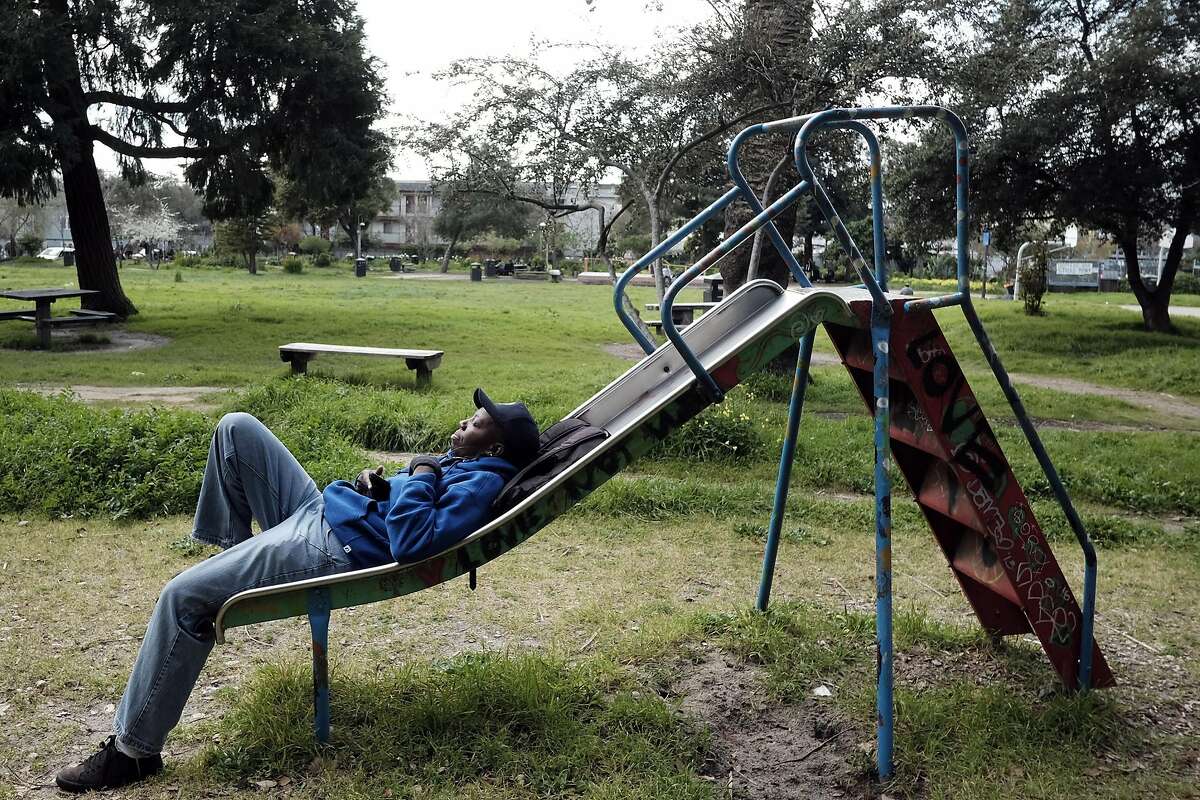 Vickie Wiggins of Richmond listens to music on her phone while relaxing at People's Park before her work shift at a local cafeteria, in Berkeley, CA, on Tuesday March 7, 2017,