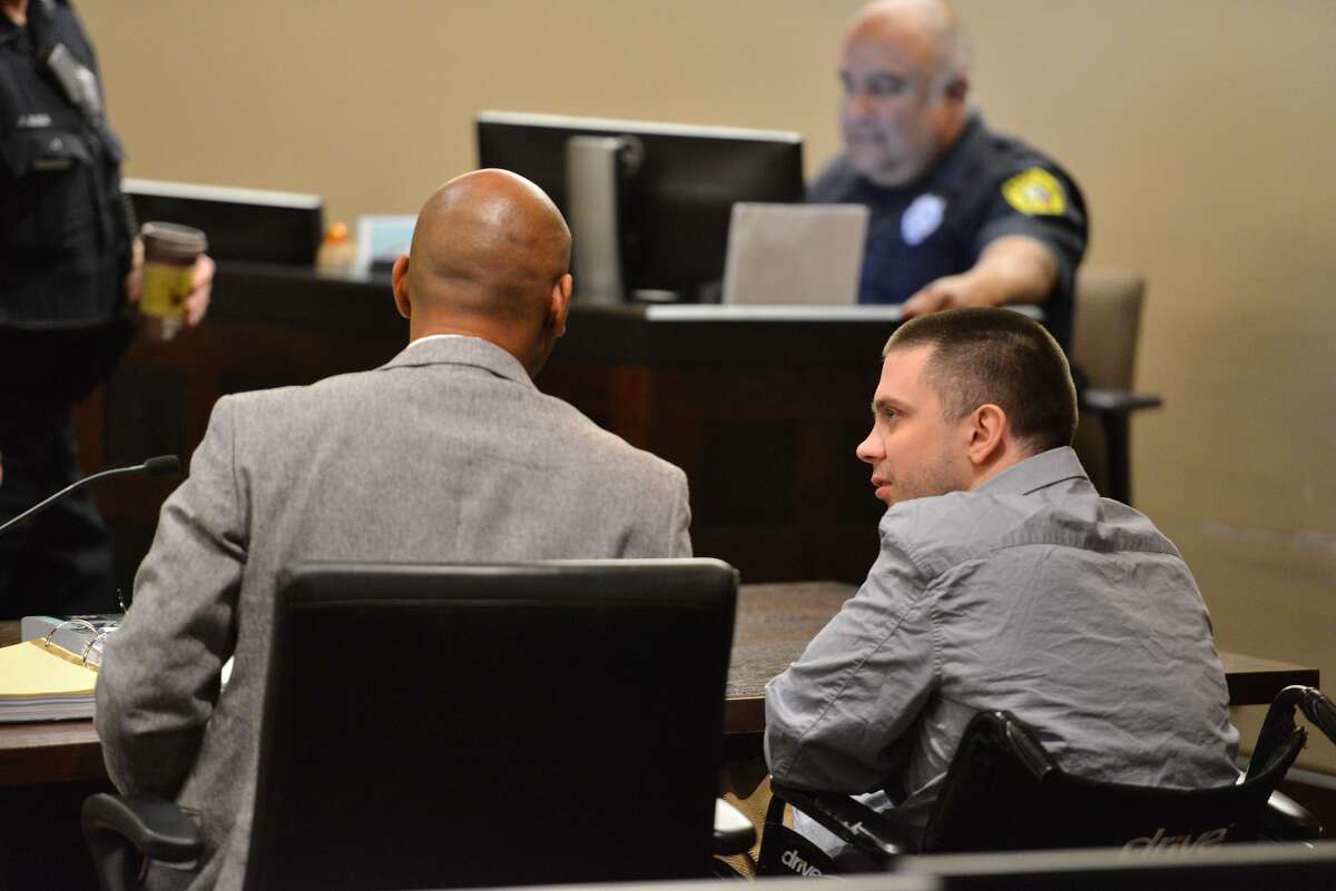 Benjamin Poehlmann (right) who is accussed of fatally shooting his girlfriend on Christmas Day 2014, talks to his attorney David Andre Woodard as his trial got underway Wednesday in Judge Steven C. Hilbig in the 187th State District Court.
