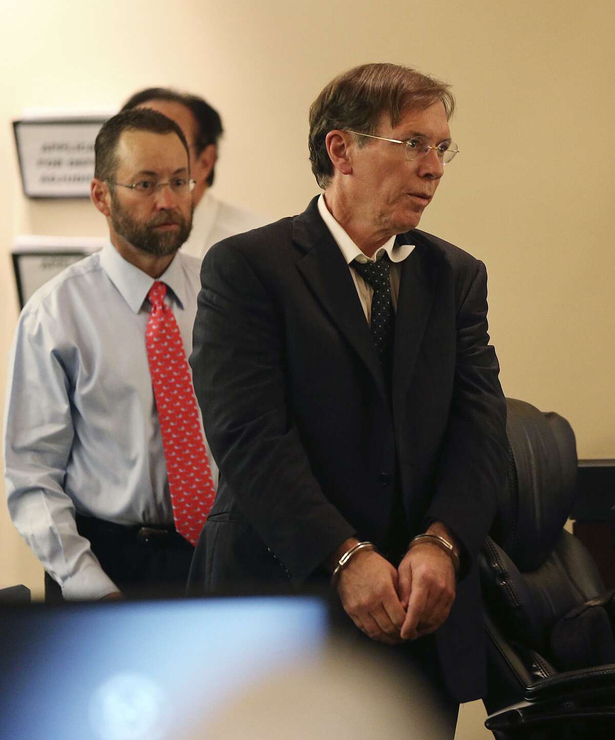 Dr. Calvin Day, right, walks back into the Bexar County 379th District Court during the punishment phase of his sexual assault trial, Monday, June 24, 2013. Day convicted of sexually assaulting a patient but later won a new trial and dismissal of the case. In back is one of his attorneys, Jay Norton.