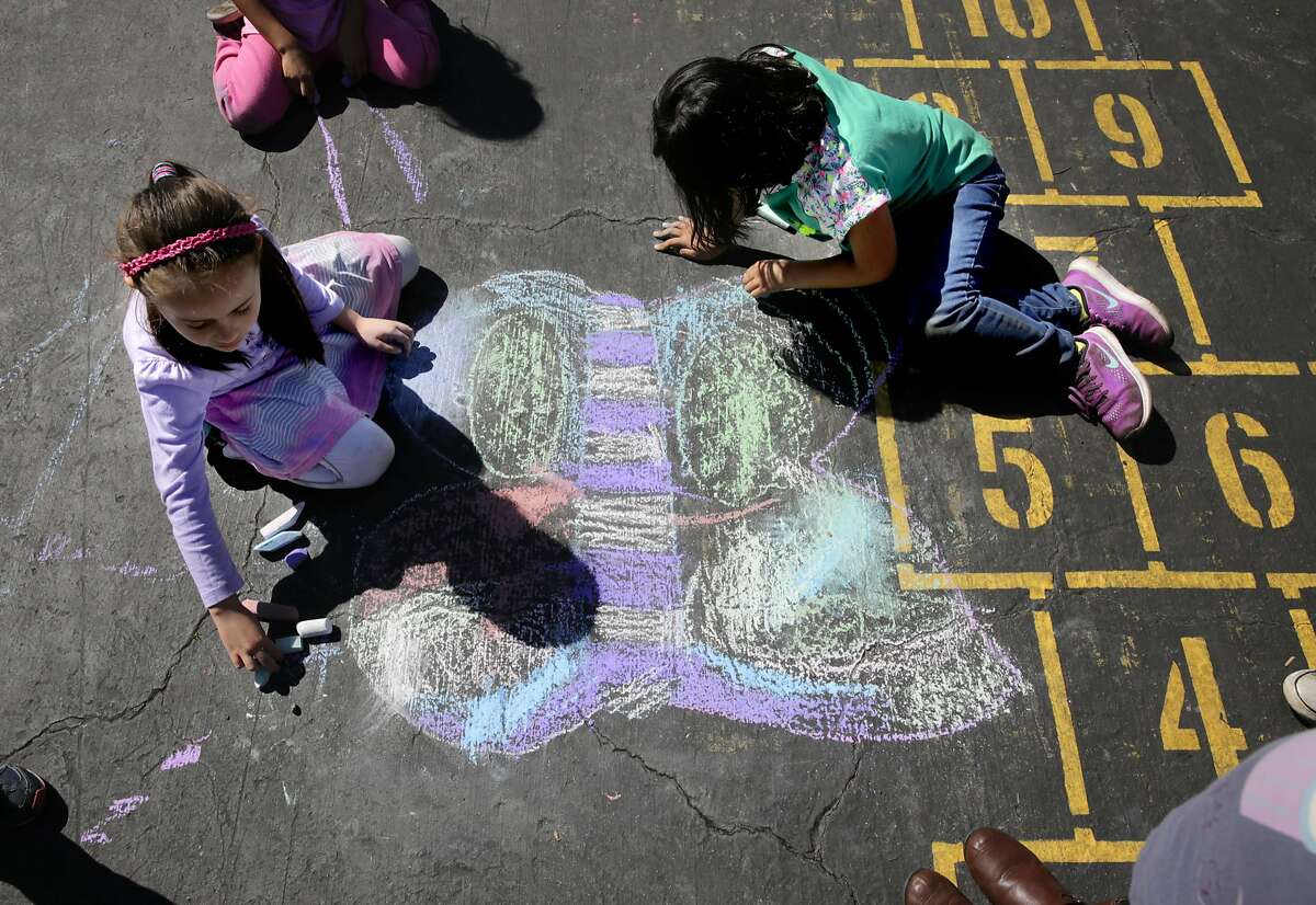 Alina Barascout, (left) and Molly Cho who are in kindergarten draw playground art during recess at Bay Farm Elementary School on Wed. March 8, 2017, in Alameda, Ca.