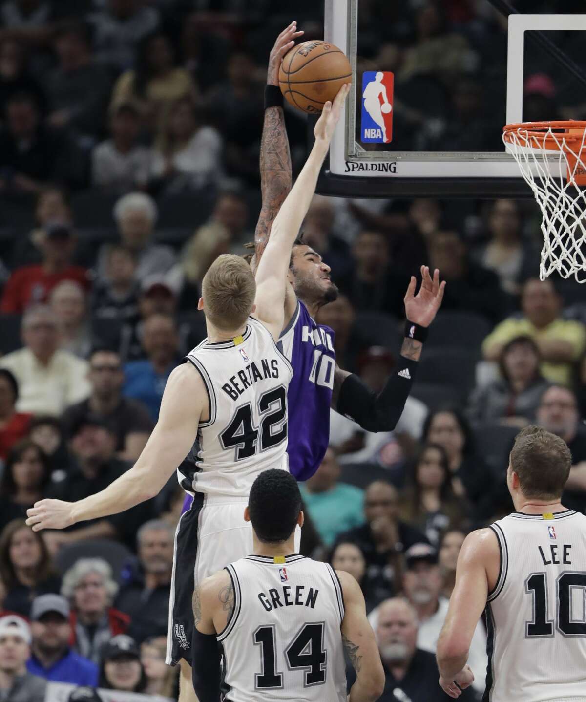 Sacramento Kings center Willie Cauley-Stein (00) is blocked by San Antonio Spurs forward Davis Bertans (42) as he tires to dunk the ball during the second half of an NBA basketball game, Wednesday, March 8, 2017, in San Antonio. San Antonio won 114-104. (AP Photo/Eric Gay)