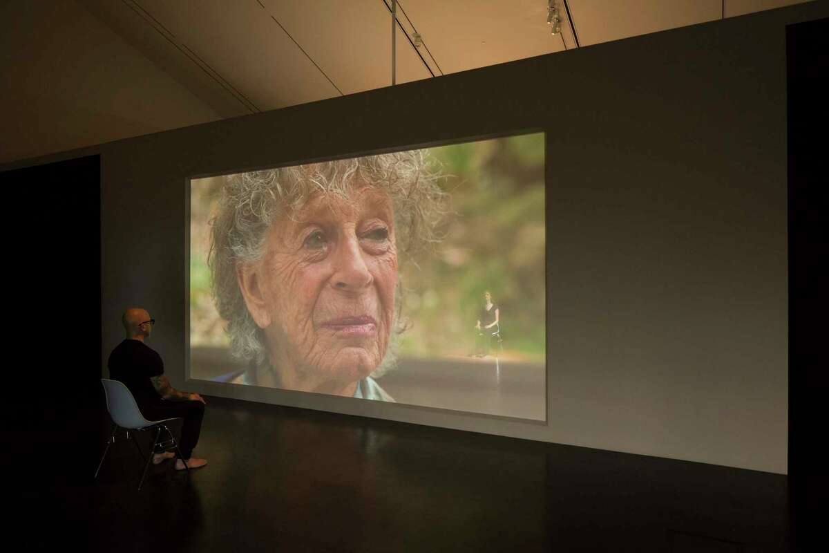 Rope Dance, 2015. Concept, title and score by Anna Halprin (shown on screen). Interpretations and variations by Janine Antoni, seated at right, and Stephen Petronio, at left. Commissioned by The Fabric Workshop and Museum, Philadelphia. Rope Dance performance part of Entangle at the Tang Teaching Museum at Skidmore College. Photograph by Arthur Evans.