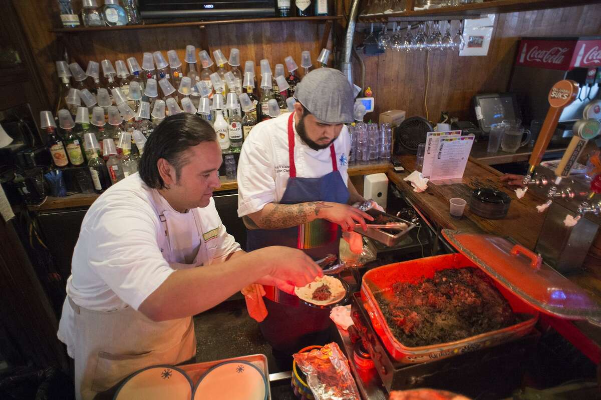Chef Johnny Hernandez and Luciano Valadez prepare barbacoa and lengua breakfast tacos for judges at the Breakfast Taco Battle at Casa San Antonio based in Old School bar and Grill Friday for South by Southwest last year.