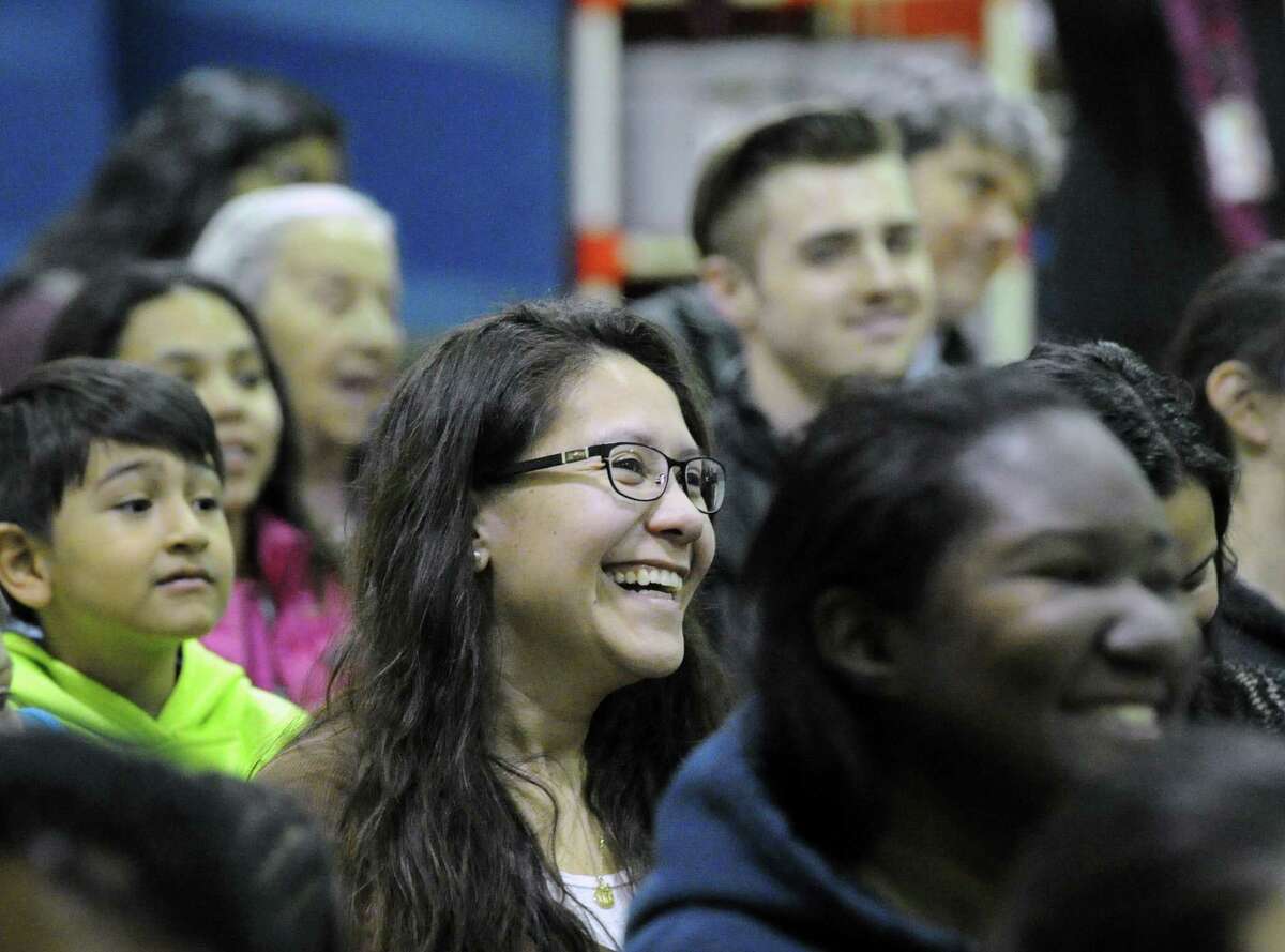 An audience member smiles during the New Lebanon School 4th & 5th grade students opening night performance of the play "A Year with Frog & Toad" at the school in Greenwich, Conn., Thursday, March 9, 2017. New Lebanon School teacher Carol Pugliano, the director of the production, said about 29 "enthusiastic" students participated in the play that is based on the musical that was written by brothers Robert and Willie Reale and the book was illustrated by Arnold Lobel. The performance took place to a standing-room-only crowd of roughly 100 people in the school's gymnasium.