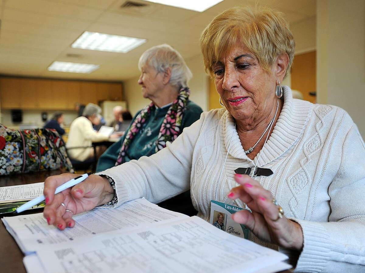 Volunteer Gloria Lanna, of Milford, reviews tax returns before filing at the AARP's Tax Aid Program at the Milford Senior Center in Milford, Conn. on Tuesday, March 7, 2017. Seniors and low income residents can have their taxes done for free on Tuesday and Thursday mornings from 9 am until noon. Lanna said that volunteers are able to complete about thirty returns per session at the Milford location.