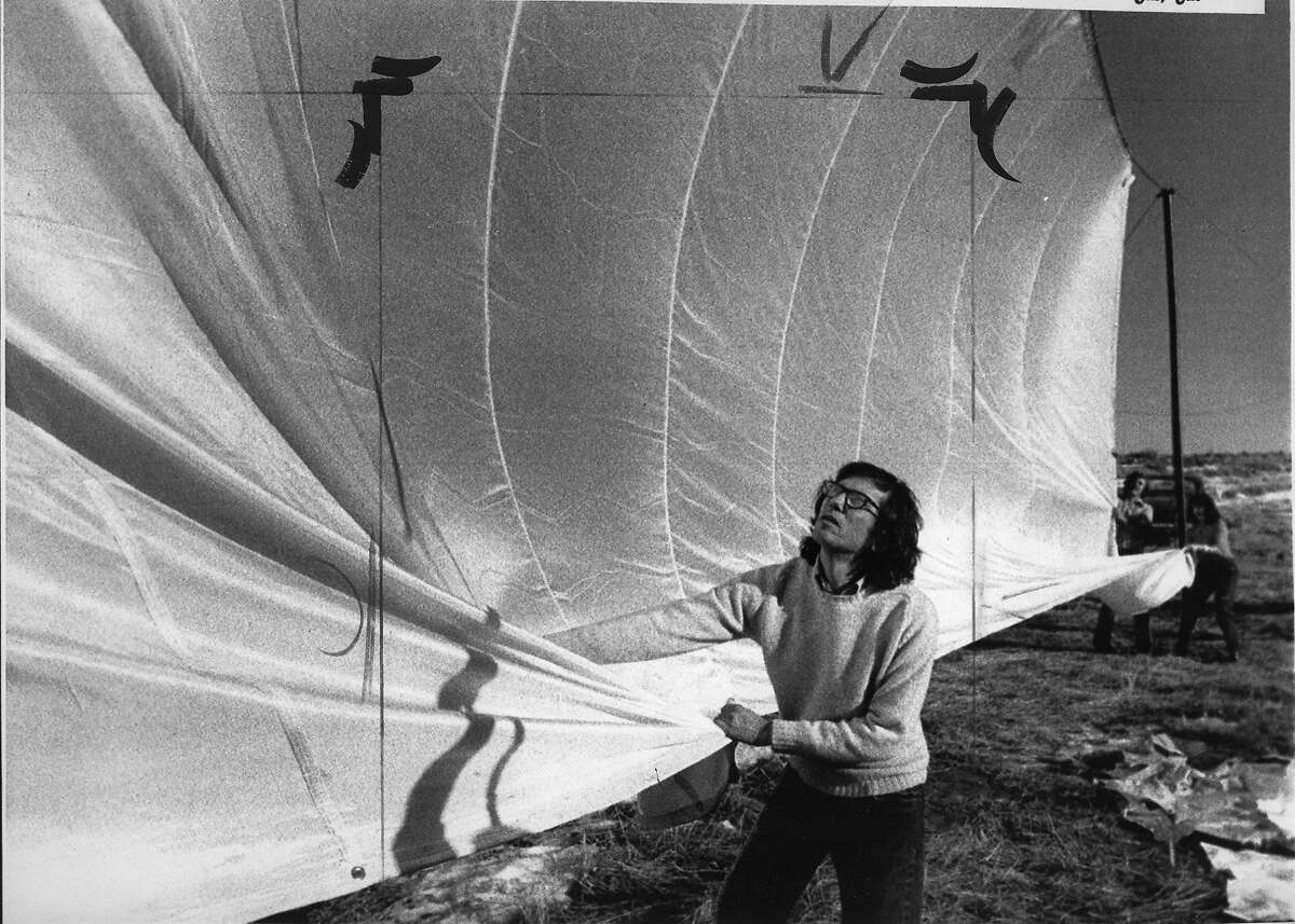 New York artist Christo Javacheff pulls on parachute type nylon cloth, which he plans to use with his next project: a 24 mile long running fence through from Petaluma to the pacific Ocean at a cost of $500,000, January 17, 1974 United Press International photo