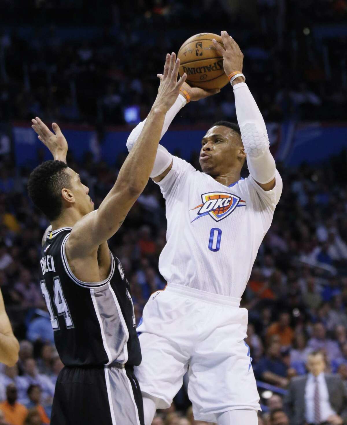 Thunder guard Russell Westbrook (0) shoots in front of Spurs guard Danny Green (14) during the first quarter in Oklahoma City on March 9, 2017.