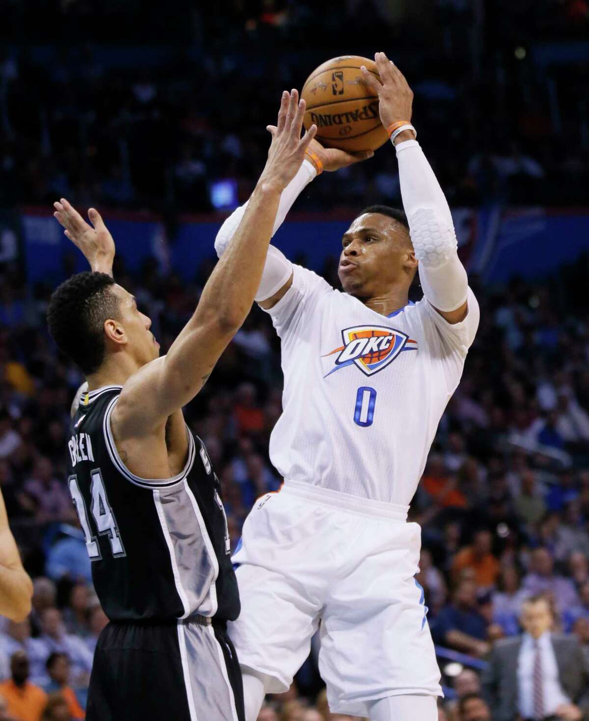 Oklahoma City Thunder guard Russell Westbrook (0) shoots in front of San Antonio Spurs guard Danny Green (14) during the first quarter of an NBA basketball game in Oklahoma City, Thursday, March 9, 2017. (AP Photo/Sue Ogrocki)