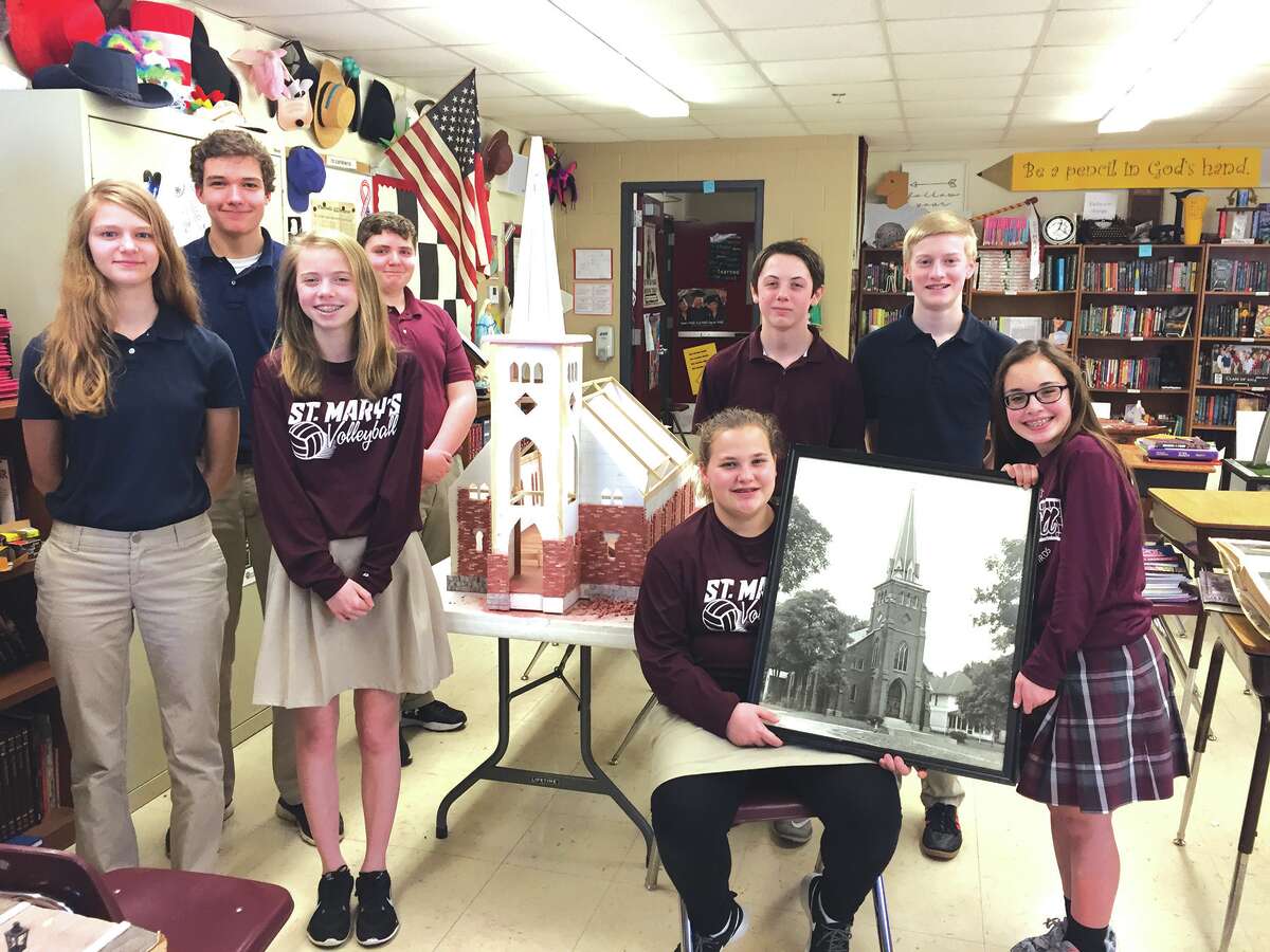 Eighth-grade students in Debbie Caulk's class show off the model of the "old" church they are building in celebration of St. Mary's 175th anniversary.