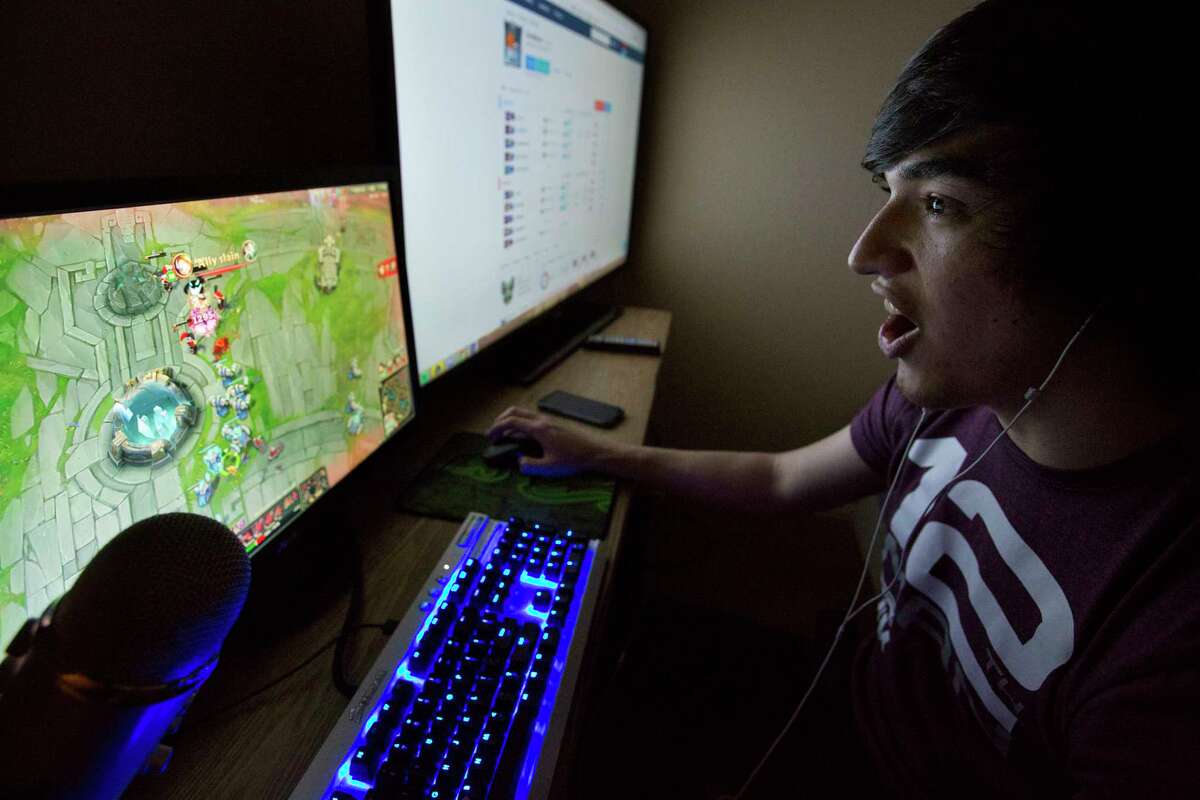 Zac Acosta, 21, reacts to a play during a League of Legend game with his Texas A&M eSports teammates in his room Saturday, March 4, 2017, in College Station. Acosta liks to play in the dark with only the glow of his two screens illuminating the room. ( Yi-Chin Lee / Houston Chronicle )