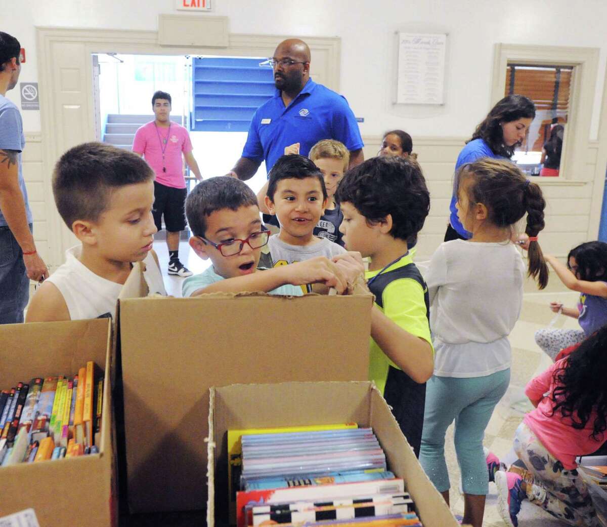 The Greenwich Alliance for Education book give-away to children at the Boys and Girls Club of Greenwich, Conn., Wednesday, Oct. 19, 2016. Julie Faryniarz, the executive director of the Greenwich Alliance for Education, said 3000 books were given away to club members.