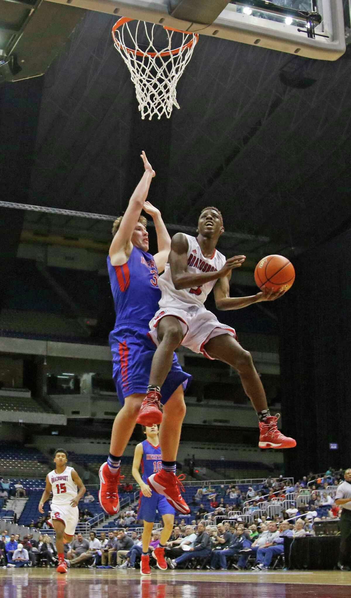 Freeport Brazoport's Jalen Johnson (3) drives on Midlothian Heritage player from 4A semi-final game between Freeport Brazosport vs. Midlothian Heritage on Friday, March 10, 2017 at the Alamodome.