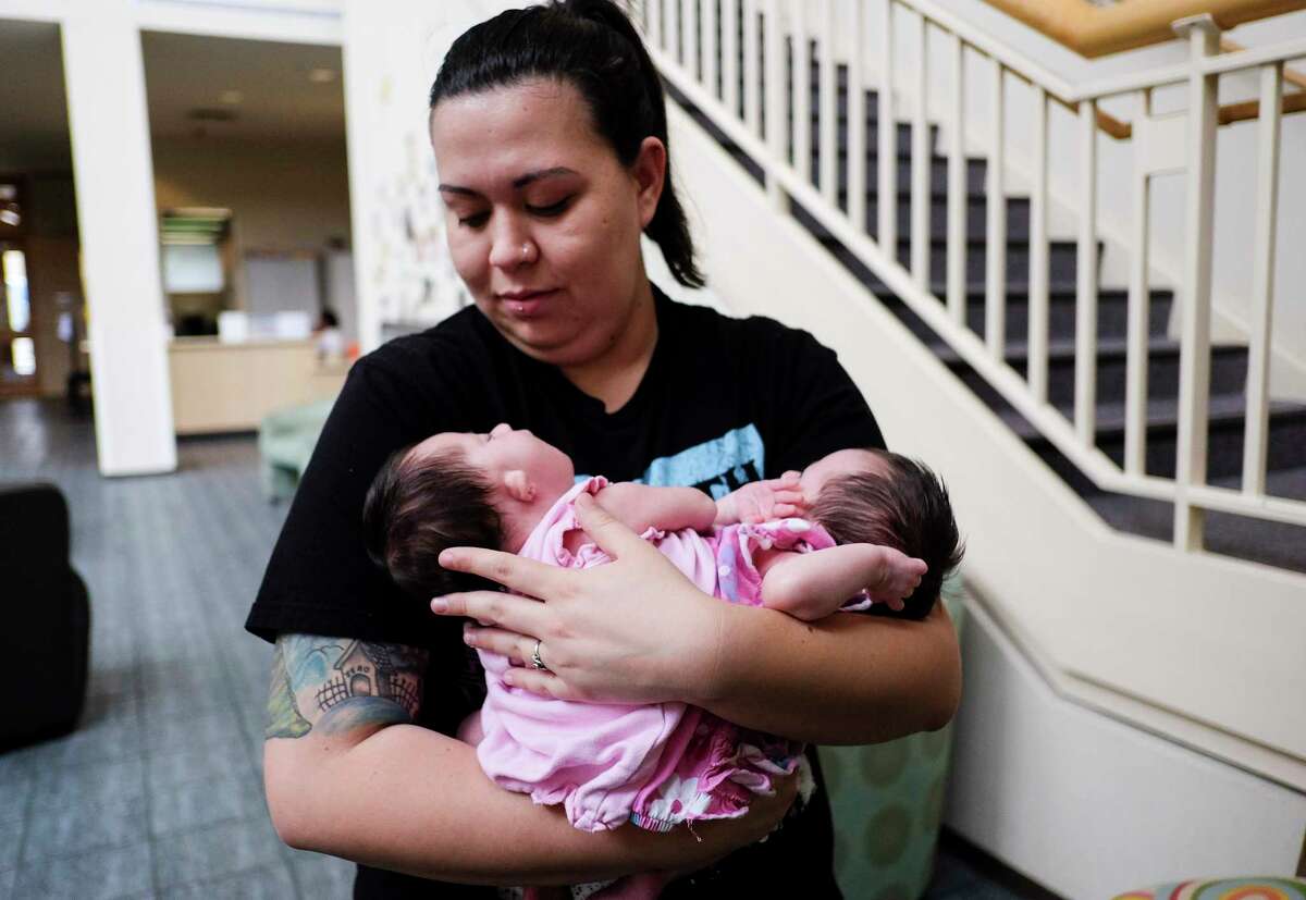 Chelsea holds onto her twins: Carter and Callie at the Ronald McDonald House on Friday, March 10, 2017, in Houston. The family uprooted their lives in Idaho to give the conjoined twins a chance for a healthy birth.