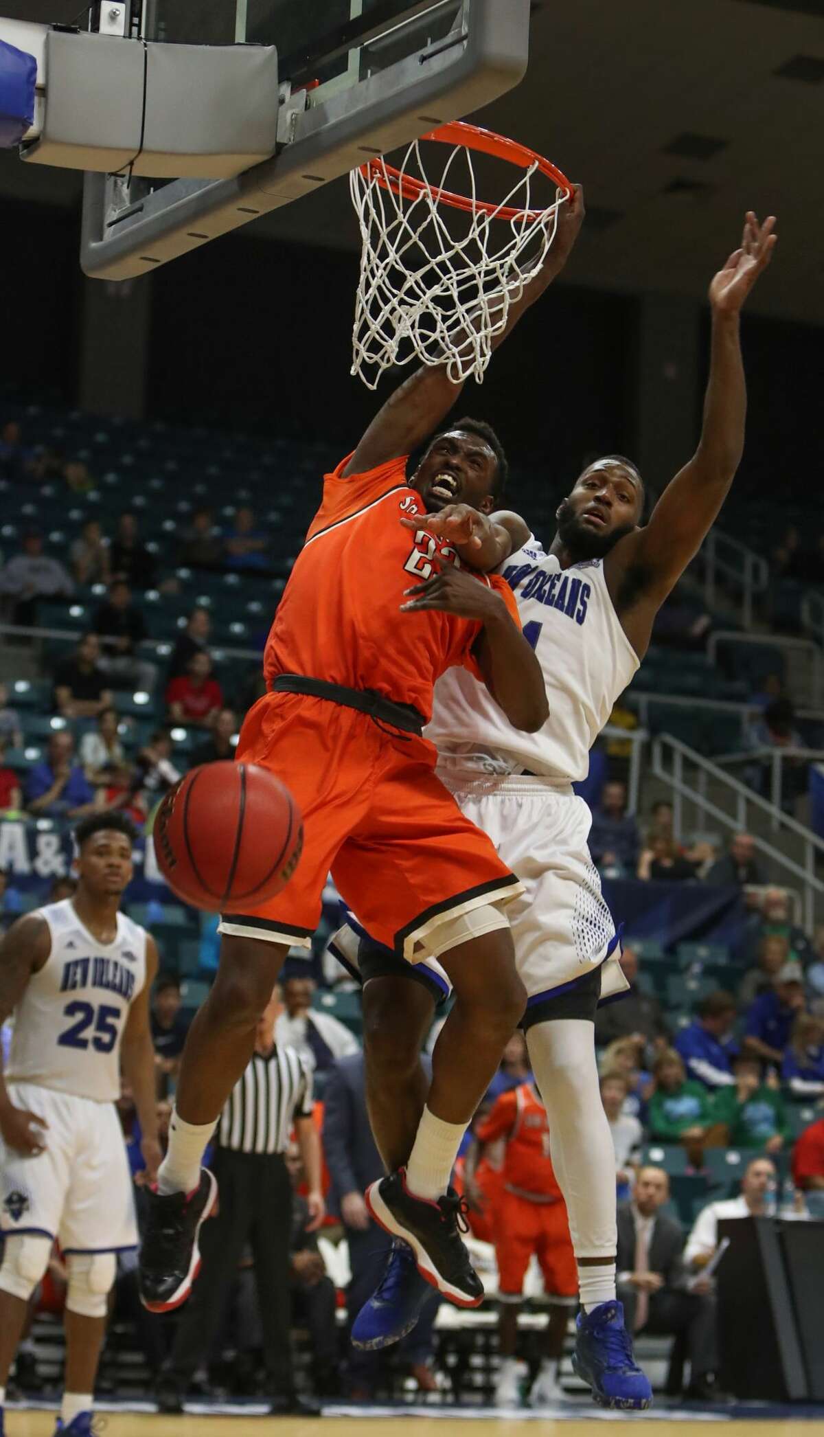 Sam Houston State forward Christopher Galbreath Jr. (23) has his shot knocked down by New Orleans guard Michael Zeno (11) during second-half action in The Southland Conference Basketball Tournament in the Leonard E. Merrell Center Friday, March 10, 2017, in Katy. ( Steve Gonzales / Houston Chronicle )