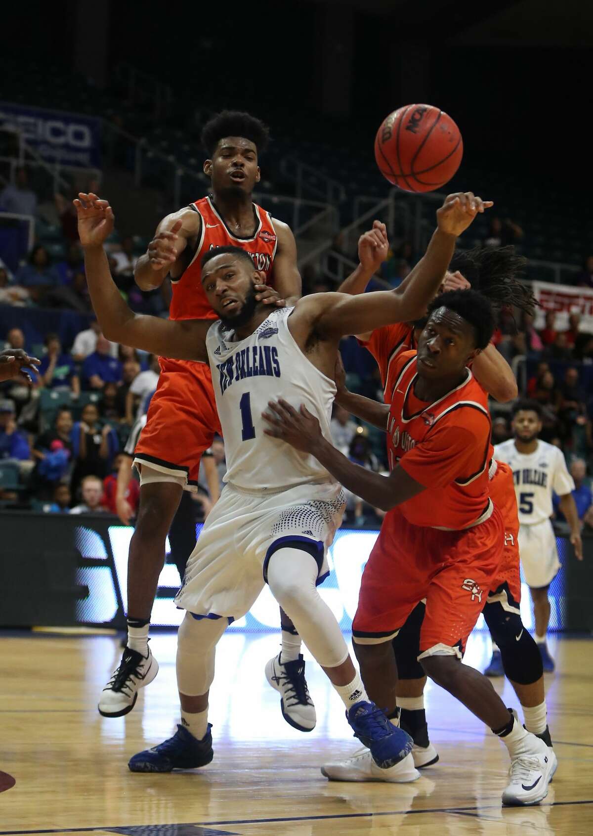New Orleans guard Tevin Broyles (1) is swarmed by Sam Houston State defenders while fighting for a loose ball during second-half action in The Southland Conference Basketball Tournament in the Leonard E. Merrell Center Friday, March 10, 2017, in Katy. ( Steve Gonzales / Houston Chronicle )