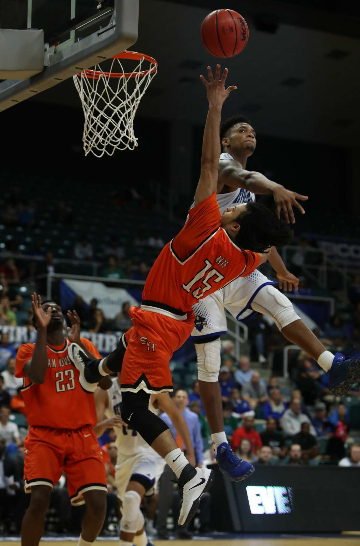 Sam Houston State guard Josh Delaney (15) gets off a shot under pressure by New Orleans forward Travin Thibodeaux (25) during second-half action in The Southland Conference Basketball Tournament in the Leonard E. Merrell Center Friday, March 10, 2017, in Katy. ( Steve Gonzales / Houston Chronicle )
