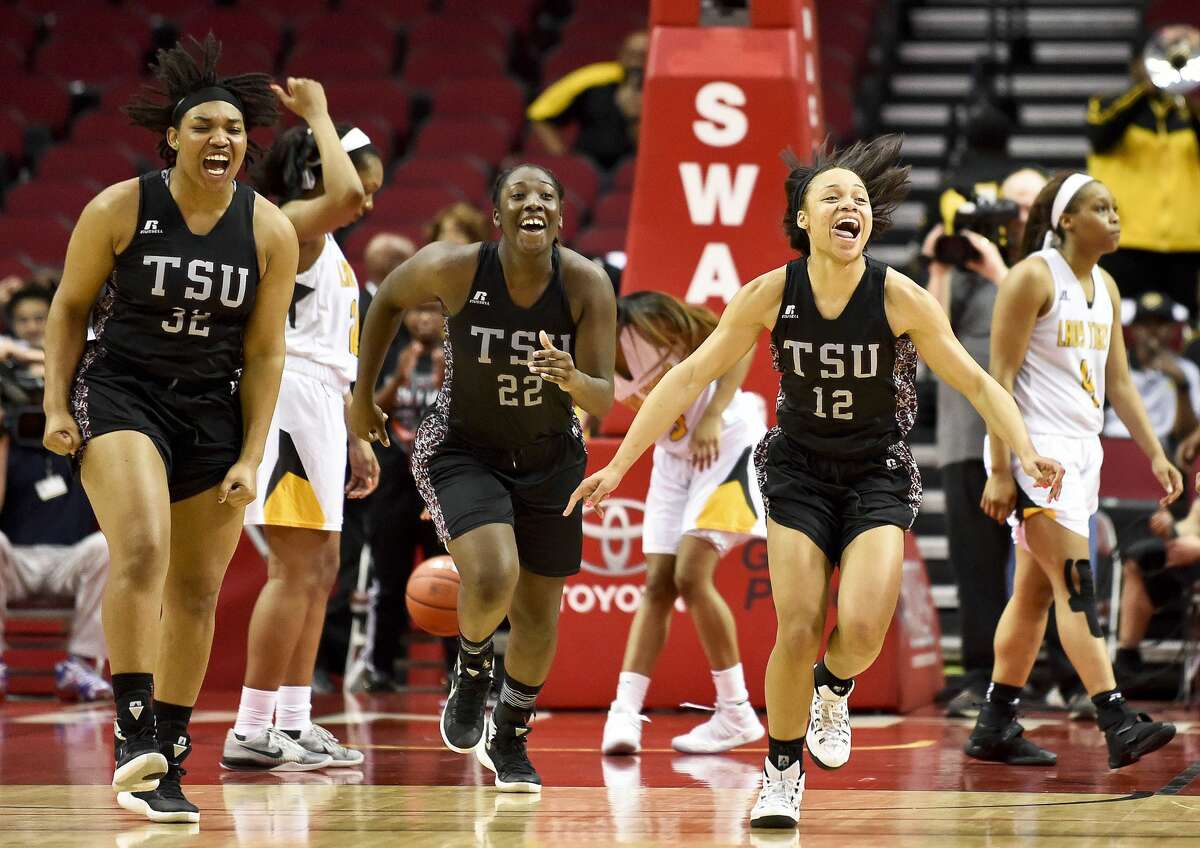 Texas Southern's Chynna Ewing (12), Breasia McElrath (22), and Nycolle Smith celebrate their 70-66 victory over Grambling as Grambling's Monisha Neal, right, walks off the court in an NCAA college basketball game in the championship of the Southwestern Athletic Conference, Saturday, March 11, 2017, in Houston. (AP Photo/Eric Christian Smith)