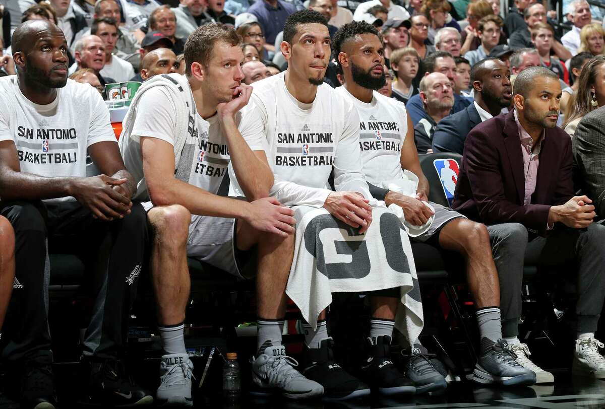 San Antonio Spurs' Joel Anthony (from left), David Lee, Danny Green, Patty Mills, and Tony Parker watch first half action against the Golden State Warriors from the bench Saturday March 11, 2017 at the AT&T Center.