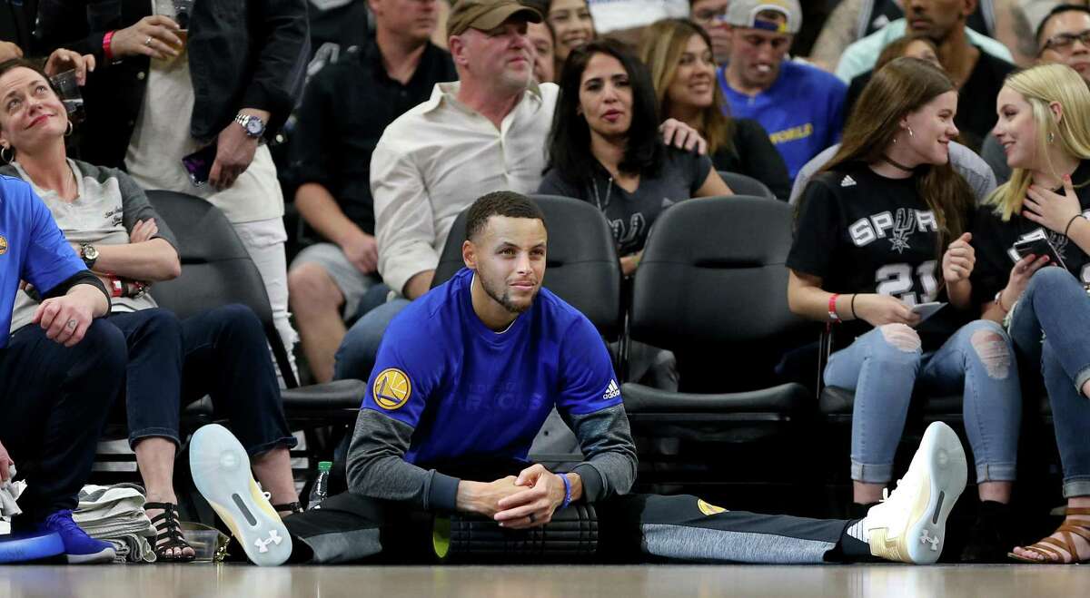 Golden State Warriors’ Stephen Curry relaxes while watching first half action against the Spurs on March 11, 2017 at the AT&T Center.