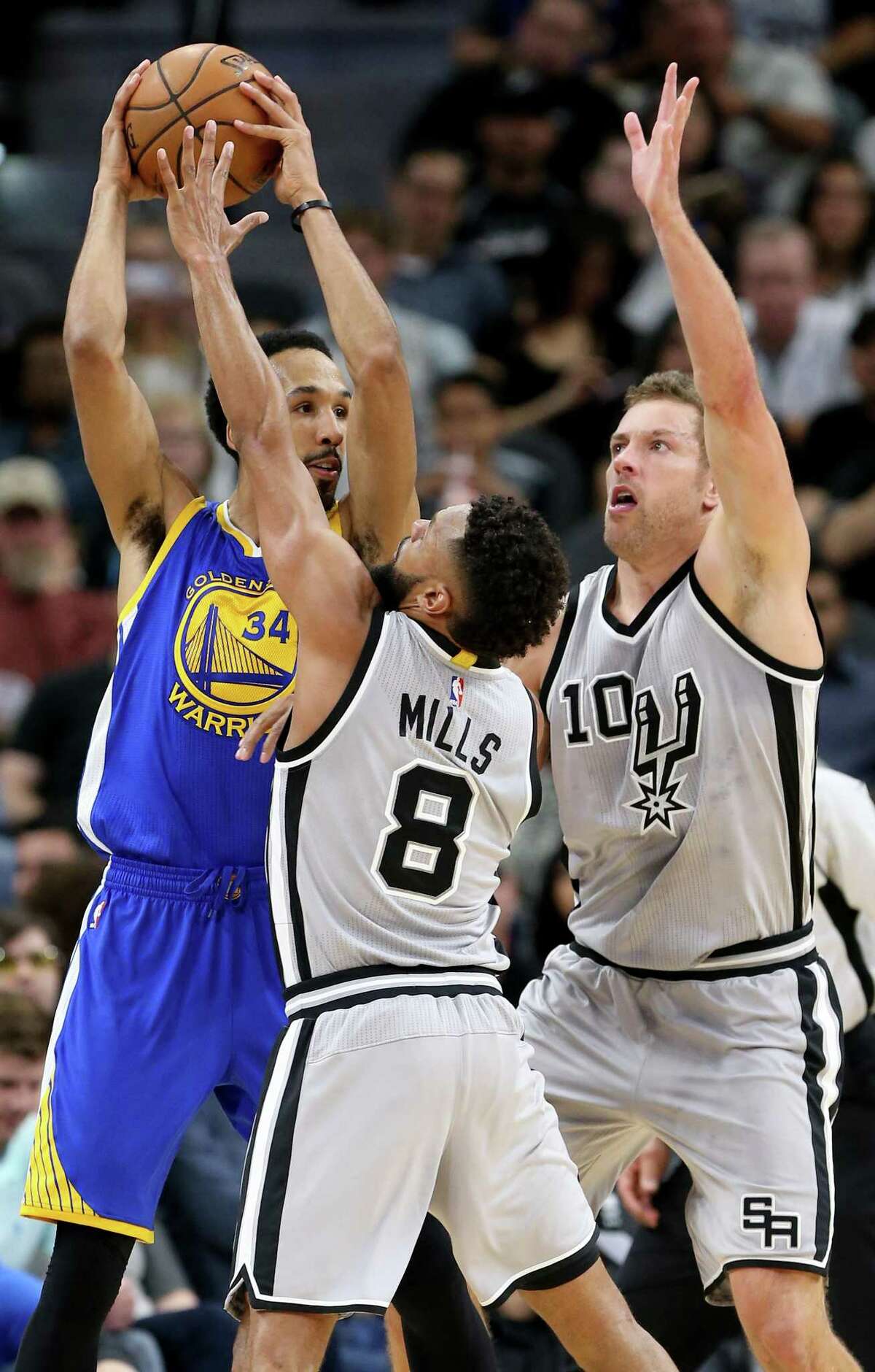 Golden State Warriors' Shaun Livingston is defended by San Antonio Spurs' Patty Mills and David Lee during first half action Saturday March 11, 2017 at the AT&T Center.