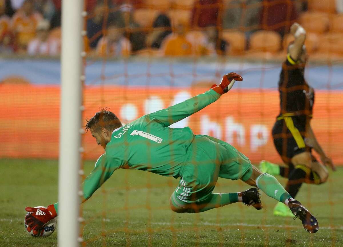 Houston Dynamo goalkeeper Tyler Deric (1) saves the ball from Columbus Crew forward Justin Meram (9) during the seconf half of the MLS soccer game at BBVA Compass Stadium Saturday, March 11, 2017, in Houston. The Dynamos defeated the Crew 3-1. ( Yi-Chin Lee / Houston Chronicle )