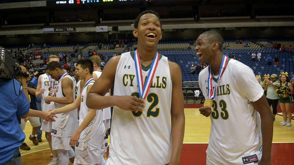 Cy Falls Eagles Maitlond Wanza (32), a senior, and junior Deshang Weaver, enjoy their medals after a 63-57 win over San Antonio Wagner in their Class 6A state final at the Alamodome in San Antonio on Saturday, March 11, 2017. (Photo by Jerry Baker/Freelance)