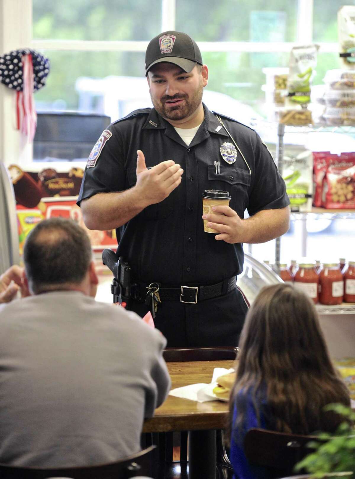 Officer Joe Kyek talks with customers of Brookfield Deli and Catering. Members of the Brookfield Police Department were at the deli for breakfast, and to have a chance to meet and talk with residents. Saturday, October 8, 2016, in Brookfield, Conn.