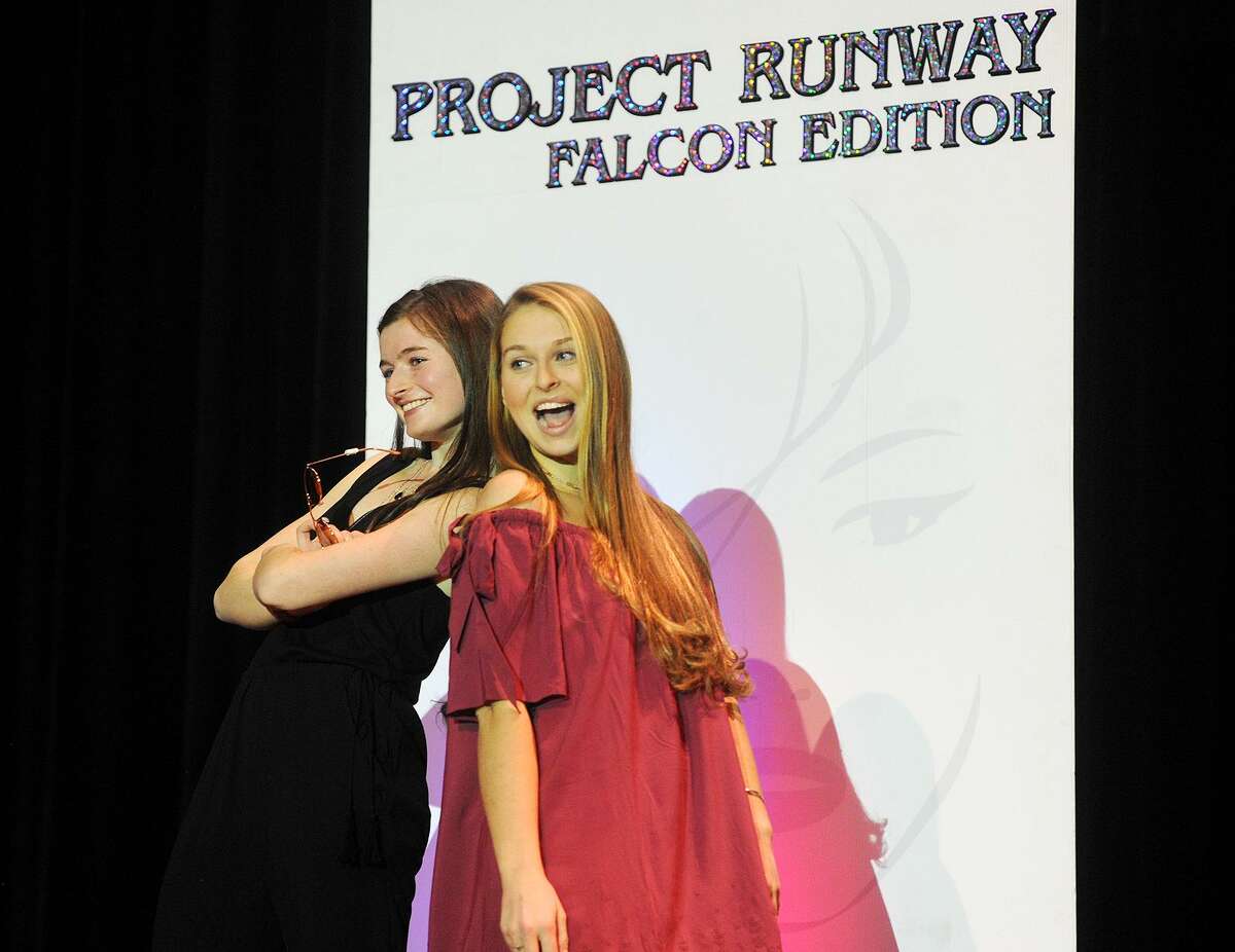 Fairfield Ludlowe High School students Kelly Kiremidjian and Caroline Wolstenholme strike a pose as they play to the audience during the school's 10th Annual Project Runway Falcon Edition fashion show at the school in Fairfield, Conn. on Sunday, March 12, 2017.