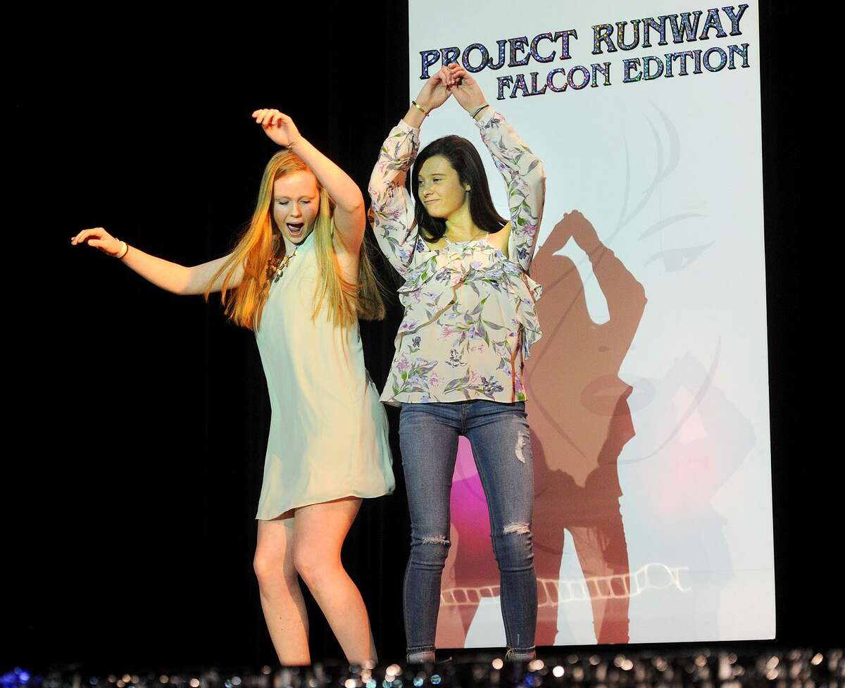 Fairfield Ludlowe High School students Meghan Donahue and Charlotte Powers do "the bump" as they play to the audience during the school's 10th Annual Project Runway Falcon Edition fashion show at the school in Fairfield, Conn. on Sunday, March 12, 2017.
