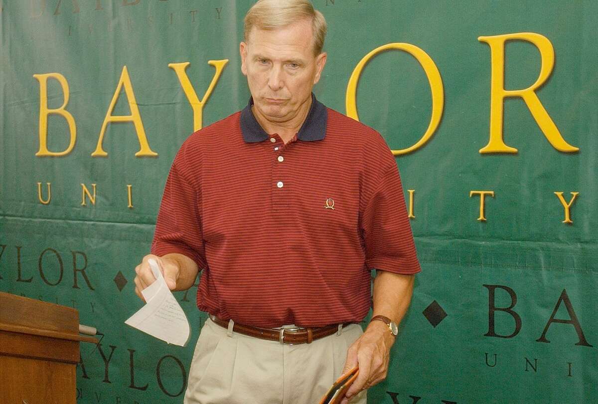 Baylor basketball coach Dave Bliss collects his notes after announcing his resignation on Aug. 8, 2003 in Waco. Bliss resigned Friday because of violations in his program that became known after the disappearance and death of a player allegedly killed by a former teammate. Baylor president Robert Sloan said the school has discovered major violations regarding players getting paid and improper drug testing.
