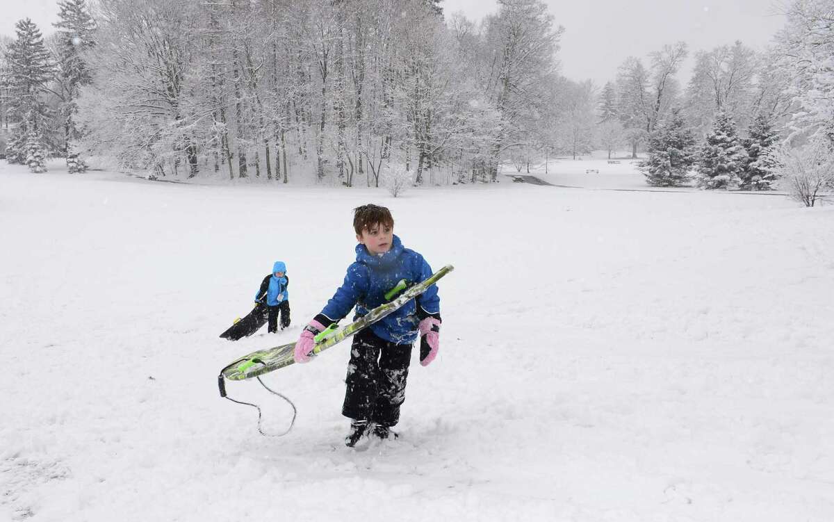 Jackson Rowley, 8, and Jack Thompson, 7, play in the snow at Winslow Park Friday, March 10, during the snowfall in Westport. About 2 to 4 inches fell over southern Connecticut, bringing bitter cold temperatures for the next few days.