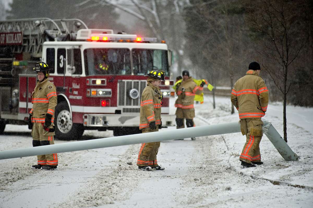 Midland fire fighters inspect a fallen light pole while working the scene of an accident on north bound Saginaw Road near Trinity Court on Monday. A vehicle traveling on Saginaw Road lost control and hit a light pole, causing it to fall into the road. A Nixle alert was sent out by Midland County Central Dispatch just after 11 a.m. Two other vehicles got into minor fender bumps avoiding the crash. No one was hurt, officials stated.