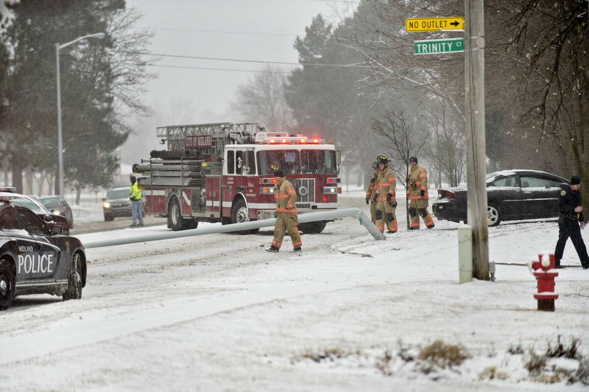 Midland police and fire department personnel work the scene of an accident on north bound Saginaw Road near Trinity Court on Monday. A vehicle traveling on Saginaw Road lost control and hit a light pole, causing it to fall into the road. A Nixle alert was sent out by Midland County Central Dispatch just after 11 a.m. Two other vehicles got into minor fender bumps avoiding the crash. No one was hurt, officials stated.