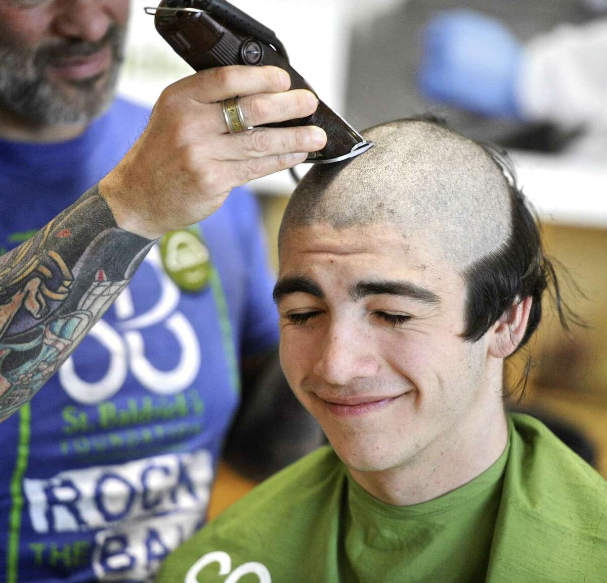 Jacob Lenes, 16, of Redding, a Junior at Joel Barlow High School, has his head shaved during the St. Baldrick's Foundation 6th annual "Brave A Shave for Kids with Cancer" event held at the school. This is Lenes's sixth year taking part in the event. Monday morning, March 13, 2017, in Redding, Conn.