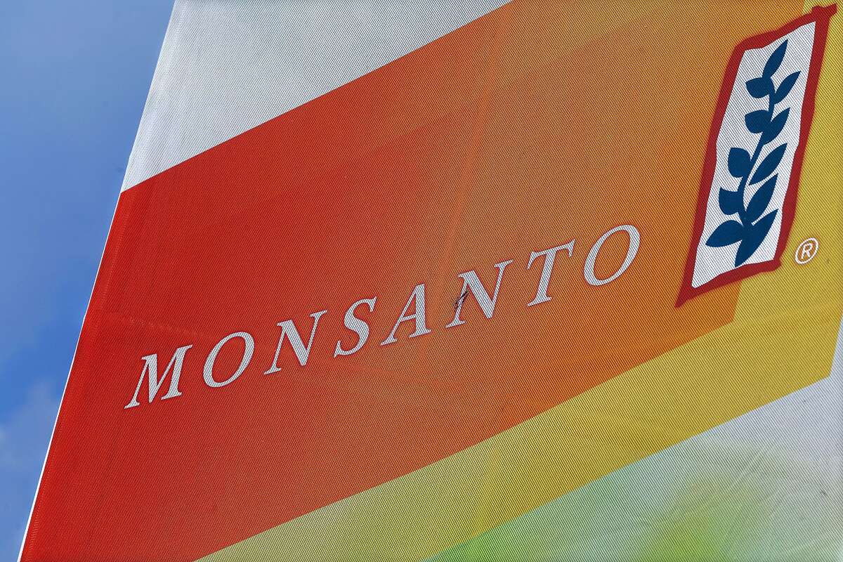 FILE - This Aug. 31, 2015, file photo, shows the Monsanto logo on display at the Farm Progress Show in Decatur, Ill. A former Monsanto Co. financial executive who tipped off regulators about the agribusiness giant's accounting practices involving rebates for its Roundup weed-killer will get nearly $22.5 million as a whistleblower, federal securities regulators announced Tuesday, Aug. 30, 2016. (AP Photo/Seth Perlman, File)
