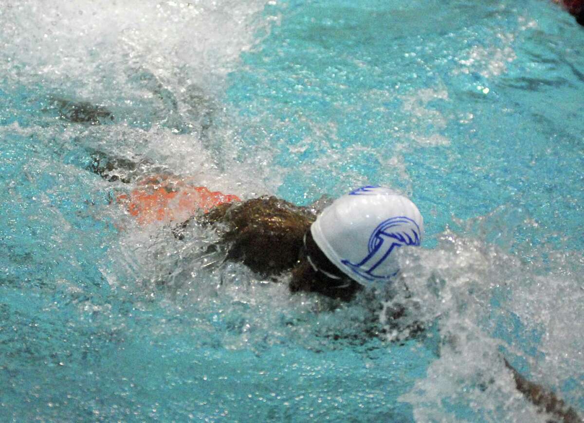 Darien's Tahj Thompson swims during the Class L championships on Monday.