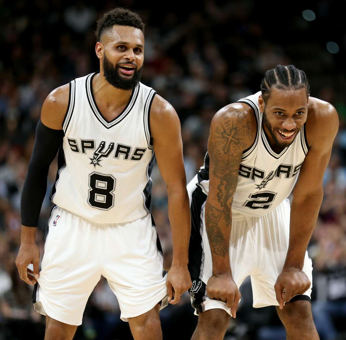 San Antonio Spurs' Patty Mills and Kawhi Leonard joke after a Leonard basket and Leonard being fouled during first half action against the Atlanta Hawks Monday March 13, 2017 at the AT&T Center.